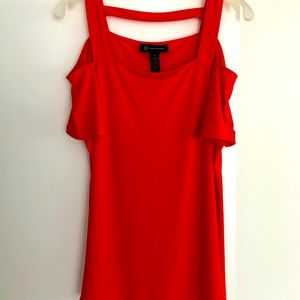 Orange INC cute top with open shoulder detail.